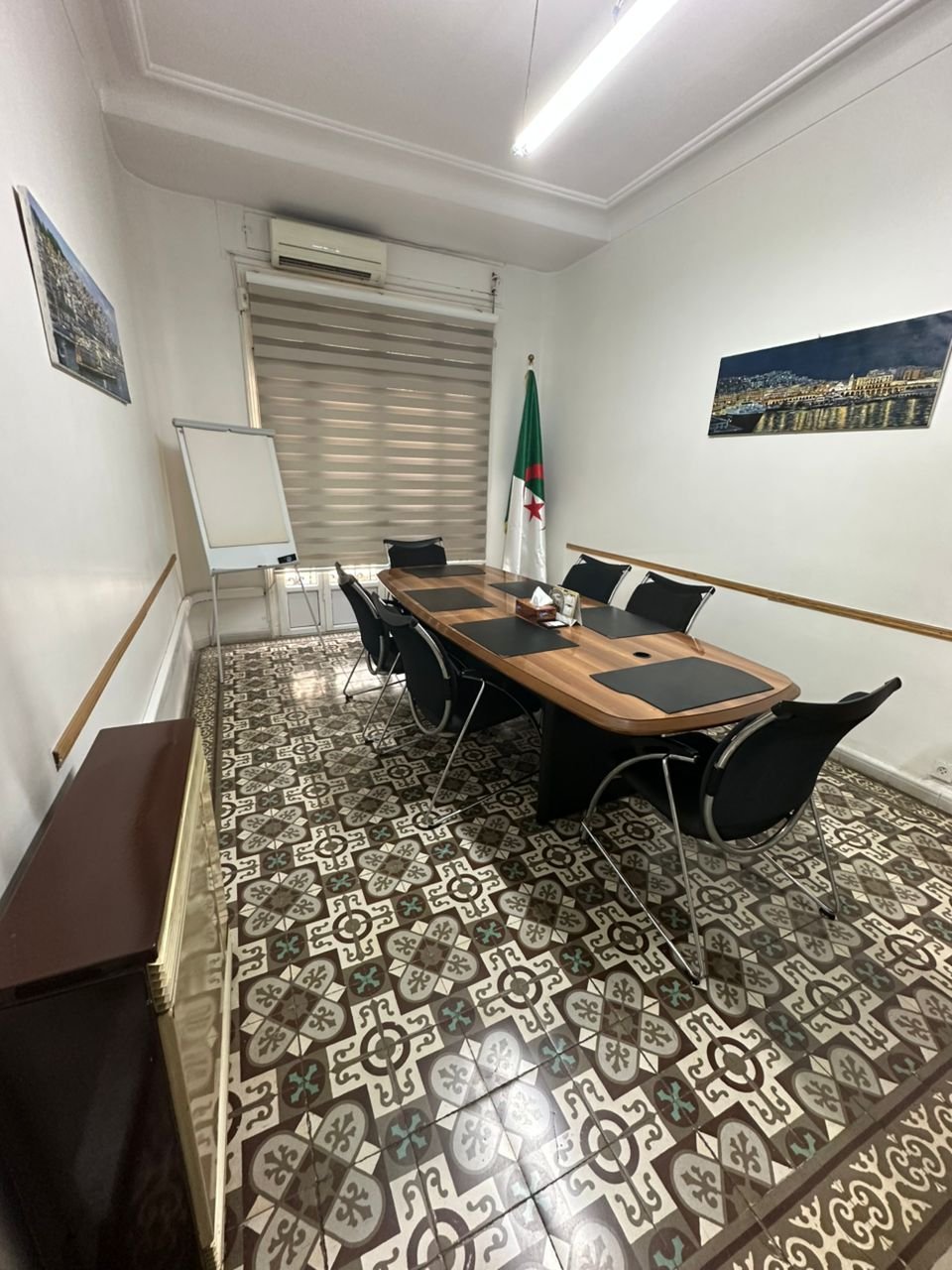 Salle de réunion avec drapeau algérien et tableau blanc